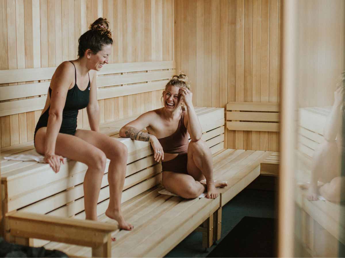 Two women enjoying a sauna at Sauna House Asheville.