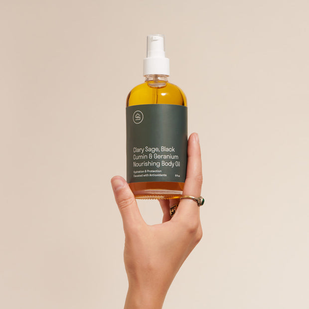 Person holding Clary Sage & Geranium Body Oil