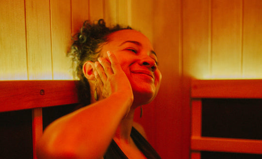 Close up of a woman sitting in a home sauna and smiling