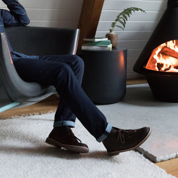 Kosmos Side Table next to a fire and a Kosmos Chair