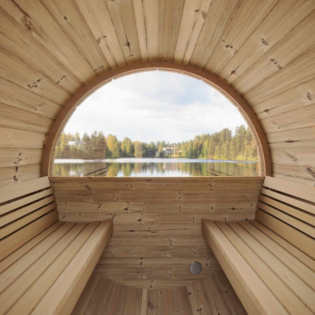 Inside the SaunaLife barrel sauna looking out of a rear window at a lake view