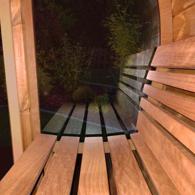 Up close view of the curved benches against the window inside of the SaunaLife barrel sauna with all glass front