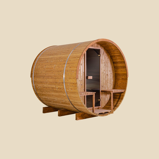 Angled view of the front and side of the barrel sauna with a porch