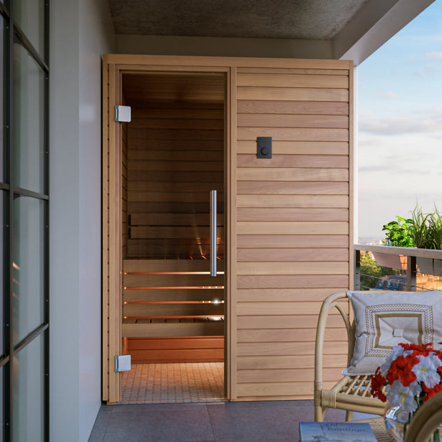 Cala wood sauna cabin installed on a covered porch with a beautiful view