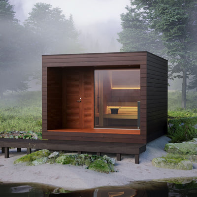 Natura outdoor cabin sauna set on the shore of a lake surrounded by trees and fog