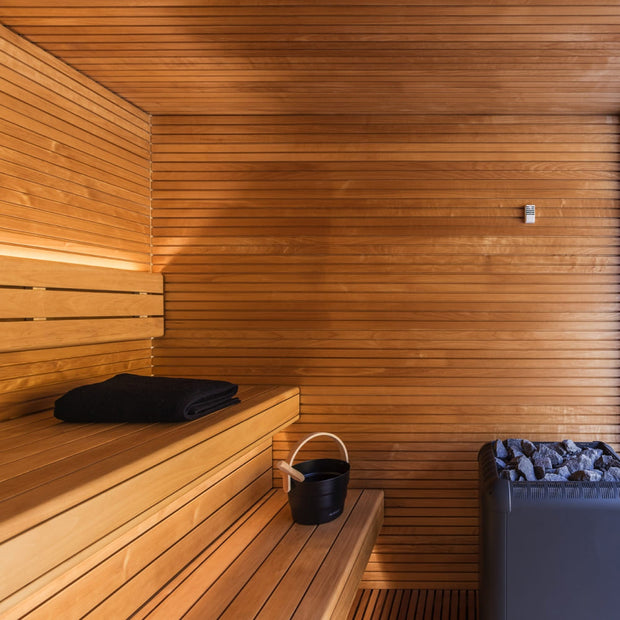 Interior thermo-aspen sauna wood paneling and sauna benches with LED lighting