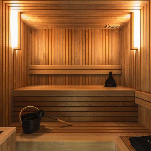 Sauna benches and lighting inside of the Familia sauna