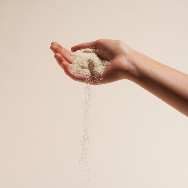 Person holding a handful of the Naked Ocean Mineral Bath Soak