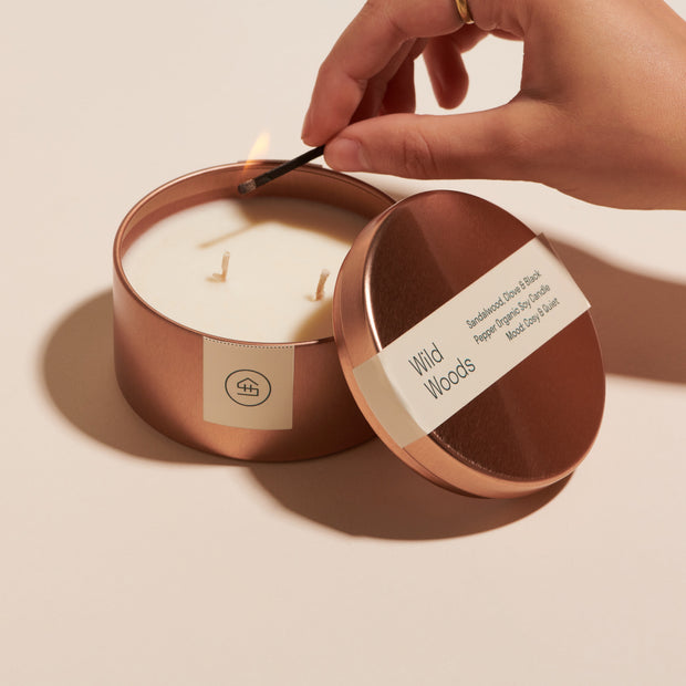 Person lighting the mini Wild Woods Organic Soy Wax Candle